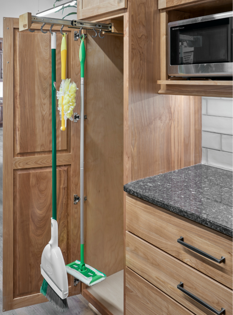 cabinet with storage insert to hang a mop, swiffer wet mop, and duster. 